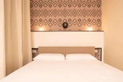 Letto o letti in una camera di Iglesias Centro Apartments In Sardinia