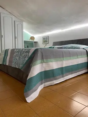 Letto o letti in una camera di La Mansardina