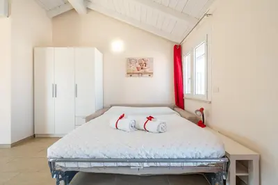 Letto o letti in una camera di Domu Balilla Cozy Loft with a panoramic terrace