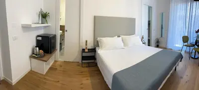 Letto o letti in una camera di Beija Flor Rooms Cagliari