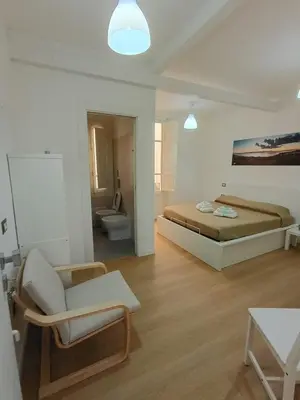 Letto o letti in una camera di WHITE MOON CAGLIARI via Dettori 5 Centro