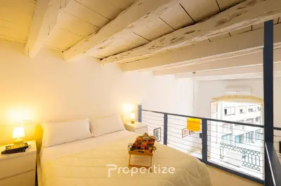Letto o letti in una camera di The White Loft by Propertize