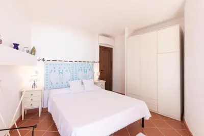 Letto o letti in una camera di Villa Capo Boi