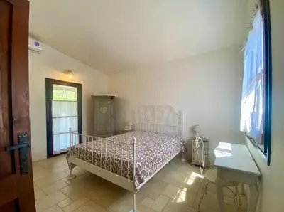 Letto o letti in una camera di Villa Meigama - Porto Giunco