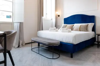 Letto o letti in una camera di Marmori Suites Cagliari
