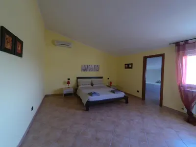 Letto o letti in una camera di La Mansarda Carbonia It