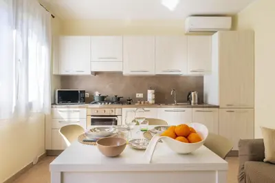 Cucina o angolo cottura di MICHI Holiday Home Tortolì