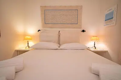 Letto o letti in una camera di Villa Ulivo - Spiaggia di Porto Giunco a piedi