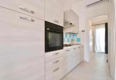 Cucina o angolo cottura di ISA - Residence in Costa Rei just 450 meters from the beach, apartments with air conditioning and outdoor private area