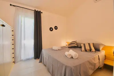 Letto o letti in una camera di ISA - Residence in Costa Rei just 450 meters from the beach, apartments with air conditioning and outdoor private area