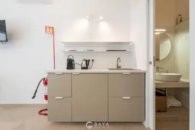 Cucina o angolo cottura di Ca' Rouge - Modern & Bright 3BR Boutique Retreat in the Heart of Carloforte