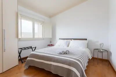 Letto o letti in una camera di Attico Eleonora- Terrazza & parcheggio in centro