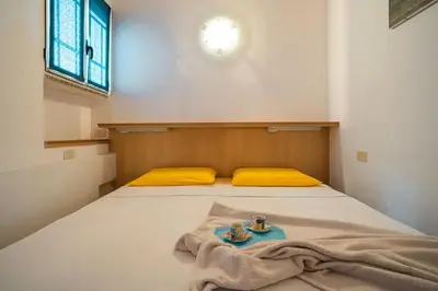 Letto o letti in una camera di Villaggio Costa del Sole