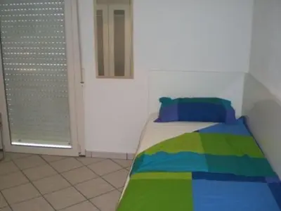 Letto o letti in una camera di Apartment Wohnung in Soleminis mit Grill by Interhome