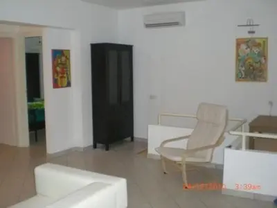 Area soggiorno di Apartment Wohnung in Soleminis mit Grill by Interhome