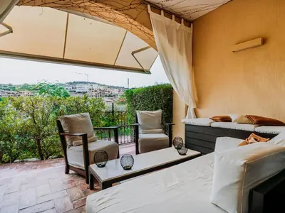 Area soggiorno di Apartment Wohnung in Villasimius mit Möblierter Terrasse by Interhome