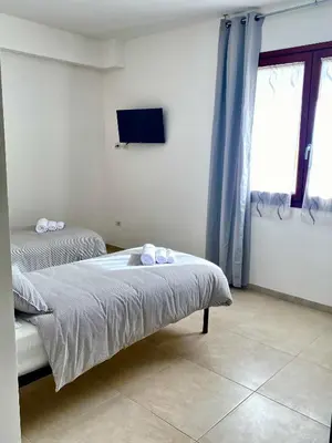 Letto o letti in una camera di Rooms Domu Ajo