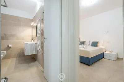 Letto o letti in una camera di Coru e Mari Appartamenti - Baia