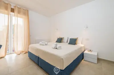 Letto o letti in una camera di Coru e Mari Appartamenti - Baia