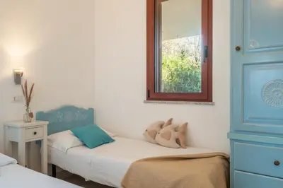 Letto o letti in una camera di Family Villa - 3 minuti dal Mare e Giardino Privato