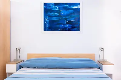 Letto o letti in una camera di GuestHost - L'Artista sul Mare Sea-Wiev Villa