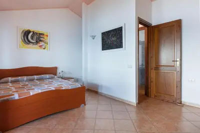 Letto o letti in una camera di GuestHost - L'Artista sul Mare Sea-Wiev Villa