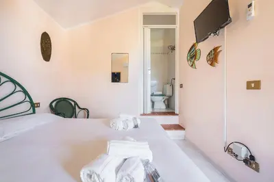 Letto o letti in una camera di Villetta Smeraldo, indipendente con giardino in zona residenziale