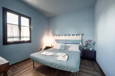 Letto o letti in una camera di Corte Luna Solanas Terrazza e Panorama Relax