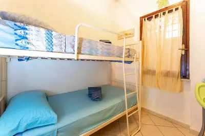 Letto o letti in una camera di Yellow House, 130m to beach SouthSardiniaHolidays
