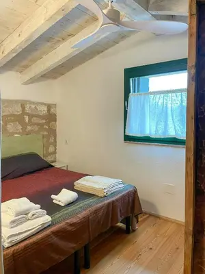 Letto o letti in una camera di Former Stable With Sea Access On San Pietro Island