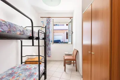 Letto o letti in una camera di GuestHost - Cozy Flat with Terrace by the Sea