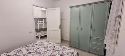 Letto o letti in una camera di Vacanze da Isidora a pochi passi dal mare