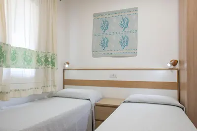Letto o letti in una camera di Cormoran Resort Villasimius