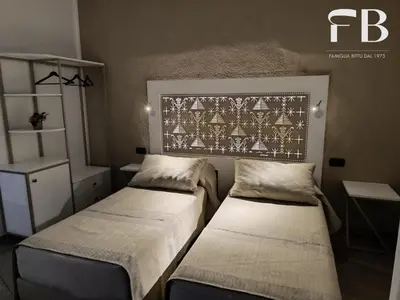 Letto o letti in una camera di Rooms FB Famiglia Bittu