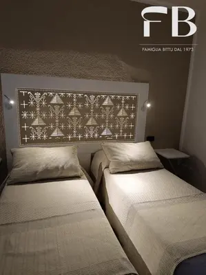 Letto o letti in una camera di Rooms FB Famiglia Bittu