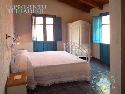 Letto o letti in una camera di S'Apposentu Teuladesu Affittacamere del Ristorante da Stefano
