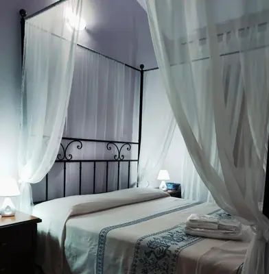 Letto o letti in una camera di Donna Violante Porto Corallo Affittacamere