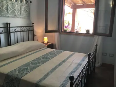 Letto o letti in una camera di Donna Violante Porto Corallo Affittacamere