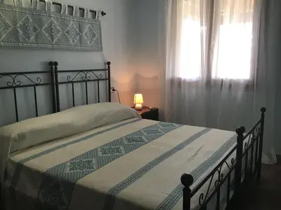 Letto o letti in una camera di Donna Violante Porto Corallo Affittacamere