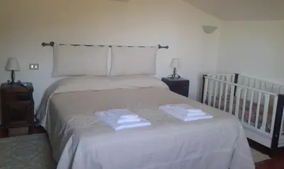 Letto o letti in una camera di B&B S'Archiotta