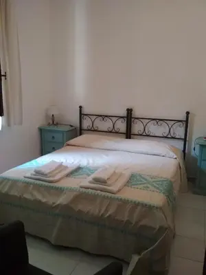 Letto o letti in una camera di B&B S'Archiotta
