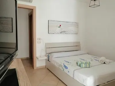 Letto o letti in una camera di Acquachiara Home Giardino e posto auto privato