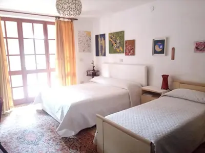 Letto o letti in una camera di Villa Corrias