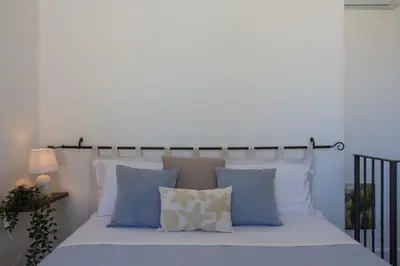 Letto o letti in una camera di Capitana Rooms