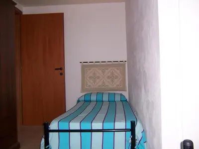 Letto o letti in una camera di Casa Vacanza Marina di Arbus