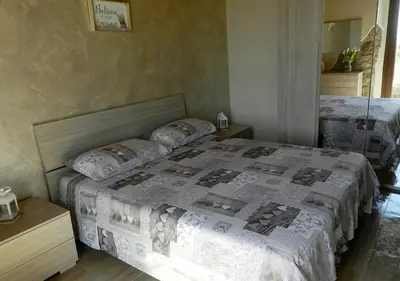 Letto o letti in una camera di B&B GLI ULIVI