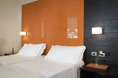 Letto o letti in una camera di UNA HOTELS T Hotel Cagliari