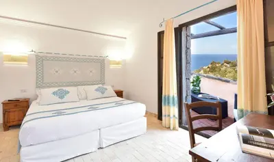 Letto o letti in una camera di Arbatax Park Resort - Borgo Cala Moresca