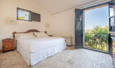 Letto o letti in una camera di Arbatax Park Resort - Borgo Cala Moresca