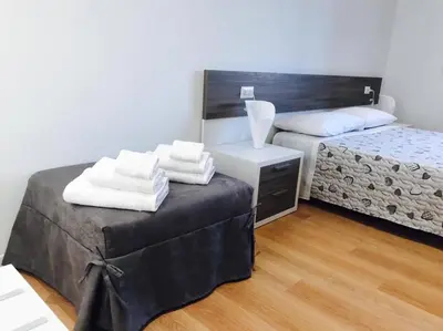 Letto o letti in una camera di Four Rooms Guesthouse